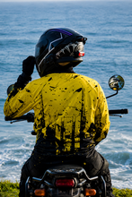 Load image into Gallery viewer, Rear view of Neon Impact Men's Riding Jersey while riding an adventure motorcycle on a coastal route