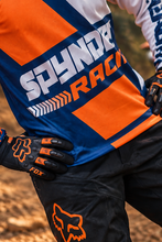 Load image into Gallery viewer, Voltage Vector Men's Riding Jersey close-up featuring orange and navy geometric racing graphics, SPYNDELL branding and lightweight motorcycle riding design for KTM and MX riders.