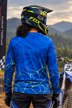 Load image into Gallery viewer, Luminous Matrix Men's Riding Jersey back view featuring blue graphics with neon green matrix lines, worn by a motocross rider beside a dirt bike.
