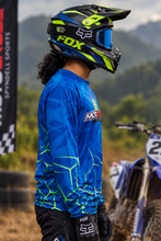 Load image into Gallery viewer, Luminous Matrix Men's Riding Jersey side view showing the blue and neon green geometric design with long sleeves, worn for motocross riding.
