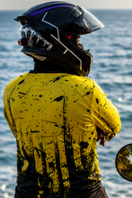 Load image into Gallery viewer, Side profile of Neon Impact Men's Riding Jersey paired with full-face motorcycle riding gear
