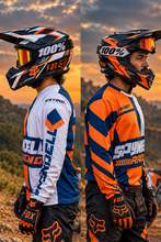Load image into Gallery viewer, Voltage Vector Men's Riding Jersey in orange, navy and white with bold racing graphics, shown on a motorcycle rider wearing MX gear and designed for KTM riders, adventure and sport motorcycle riding.
