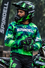 Load image into Gallery viewer, Woodland Ranger Men's Riding Jersey in green camouflage with bold SPYNDELL branding, worn by a motorcycle rider in a forest setting.
