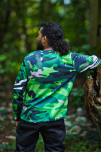 Load image into Gallery viewer, Close-up of the Woodland Ranger Men's Riding Jersey sleeve showing the detailed green camouflage print and breathable riding fabric.
