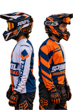 Load and play video in Gallery viewer, Voltage Vector Men's Riding Jersey showcased in orange, navy and white racing graphics, featuring front, side and riding views for KTM riders, MX, adventure, touring and motorcycle enthusiasts.

